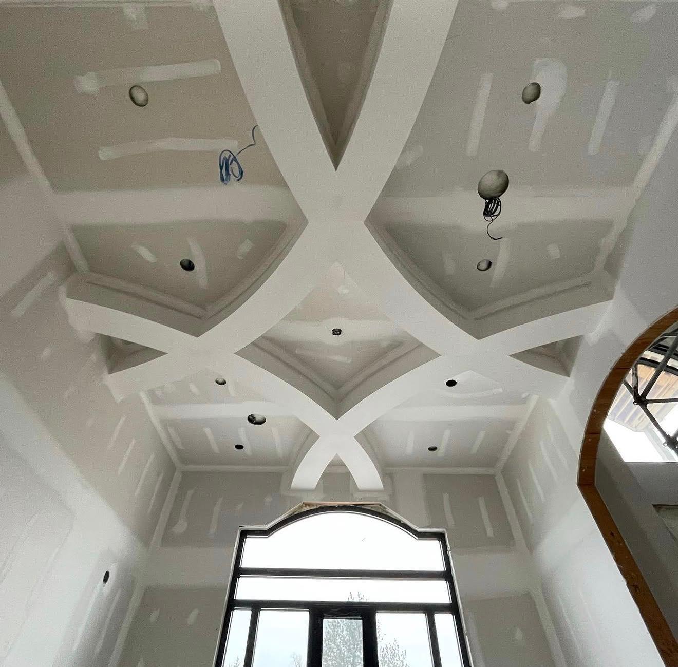 Custom ceiling feature during drywall finishing and lighting preparation